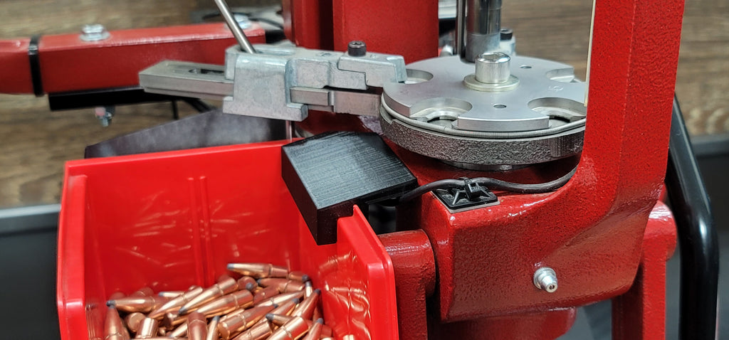 Improved finished round output bracket for the Hornady Lock n Load